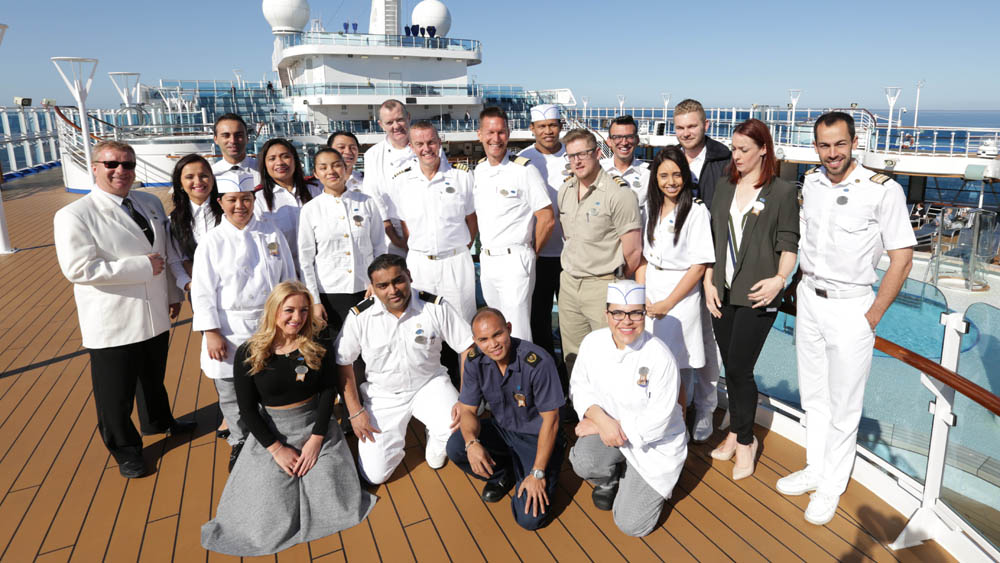 FROM WILD PICTURES THE CRUISE Thursday 3rd March 2016 on ITV Pictured:The crew of the Regal Princess on deck With unique access to one of the world’s largest luxury cruise ships, this new series follows life on board for the crew of 1400 who live and work on board the Regal Princess for up to 9 months at a time; from battling leaks to seeking promotions and from tense navigation challenges to trying to keep their relationships afloat. Tonight, as the 11 day voyage around the Baltic from Copenhagen to St Petersburg begins, the guests have more than relaxing on their mind – they’re vying for the coveted award of the most travelled passenger. Some cruise superfans have spent up to 7 or 8 years of their lives aboard. Martha & Rusty Underwood are in the running but say “These people have so many cruises, the only way we will ever catch up is if they die and we don’t!” The crew’s entertainment team is joined by new dancer Dulcie, from Portsmouth, but will she make the grade as a professional dancer? The inimitable Timothy is charming passengers on the front desk but has his eye firmly on a job with ‘ship bestie’ Emma doing shore excursions. And ex navy engineer Scott, from Darlington, joins the engineering team and soon has to find the source of a leak – no mean feat when you’re dealing with hundreds of miles of pipes. © Wild Productions For further information please contact Peter Gray 0207 157 3046 peter.gray@itv.com This photograph is © ITV and can only be reproduced for editorial purposes directly in connection with the programme THE CRUISE or ITV. Once made available by the ITV Picture Desk, this photograph can be reproduced once only up until the Transmission date and no reproduction fee will be charged. Any subsequent usage may incur a fee. This photograph must not be syndicated to any other publication or website, or permanently archived, without the express written permission of ITV Picture Desk. Full Terms and condition