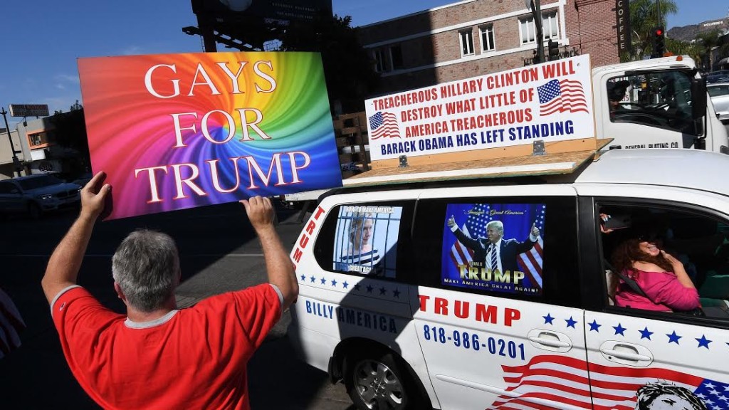 Supporters of Republican presidential hopeful Donald Trump, including gay rights groups, protest against alleged bias outside the CNN offices in Hollywood, California on Oct. 22, 2016.