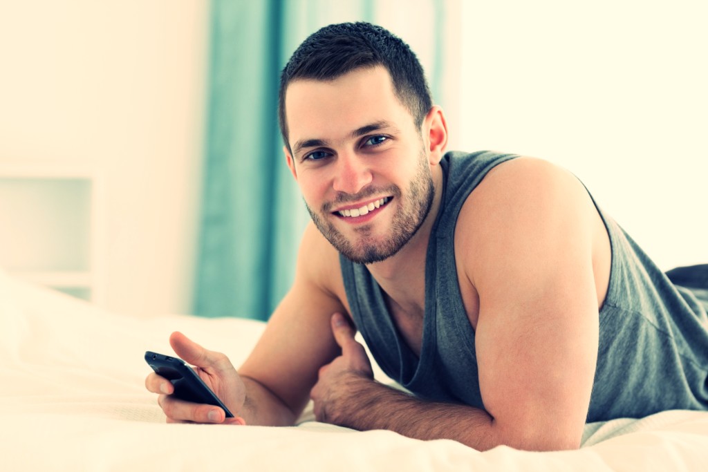 Happy man using his mobile phone