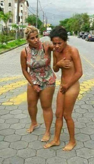 A furious wife attacks her husband's younger lover  after catching them together in bed before frogmarching her naked through the street in Cubatao, Sao Paulo, Brazil (Fee 40 for 1st picture, 20 for second, 15 for third and capped at 75 for unlimited supplied pictures and stills and 50 for video)